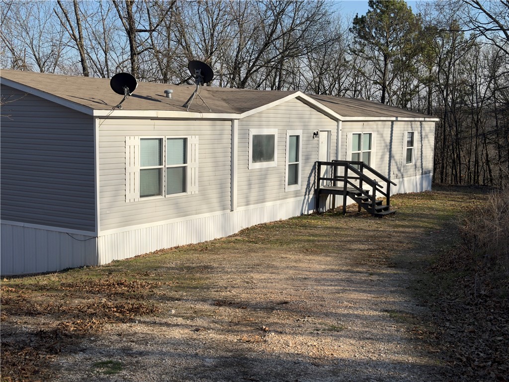 Space to spread out and room to breathe! This well-maintained 2017 double wide sits on approximately 3.45 acres just outside beautiful Eureka Springs, offering the peaceful country setting buyers are searching for.

Inside, you’ll find a spacious 4-bedroom, 2-bath layout featuring two living areas, perfect for entertaining, a game room, or flexible family space. Recent updates include new carpet and laminate flooring, plus a full set of sleek black kitchen appliances that give the kitchen a fresh, modern feel.

Step outside and enjoy the quiet surroundings, open space, and endless possibilities that come with acreage living. Whether you're looking for a full-time residence, weekend retreat, or investment opportunity, this property delivers comfort, space, and value in a scenic Ozark setting.