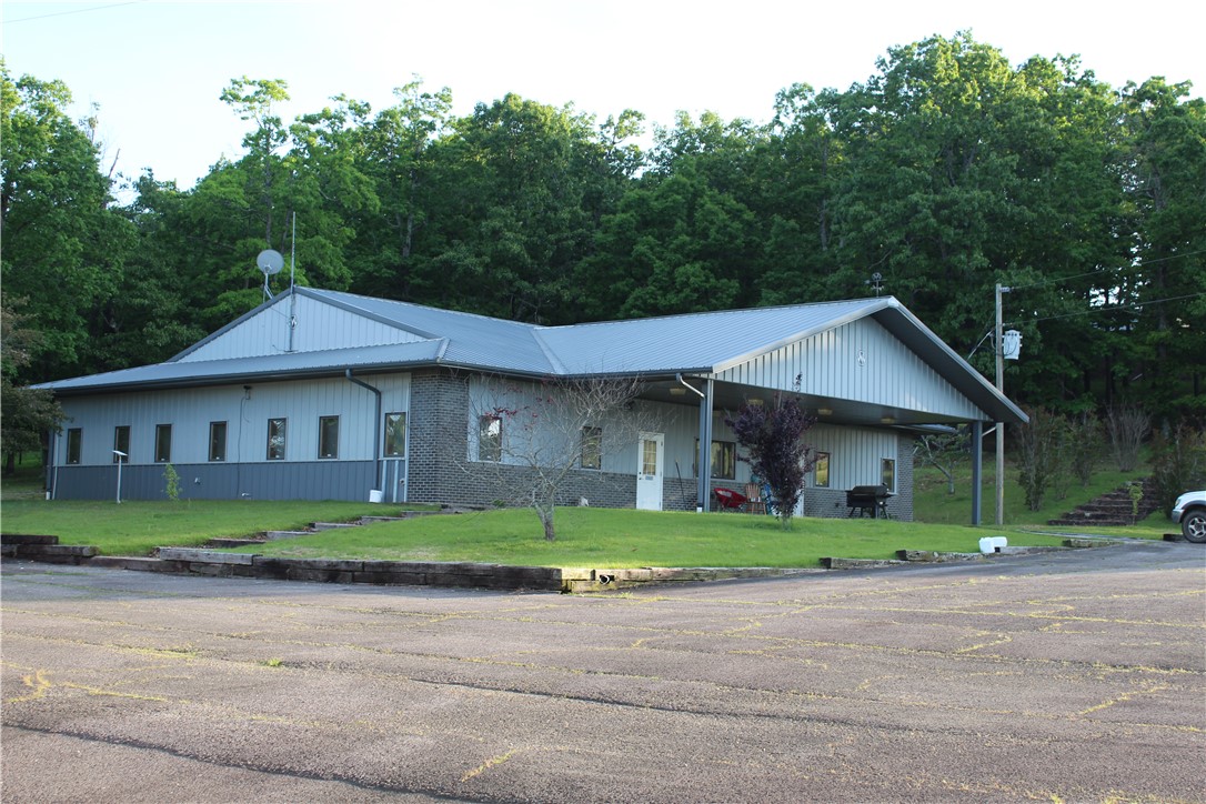 4,288 sqft Office/House, 50X90 insulated red iron shop, 2500 Sqft Insulated red iron warehouse with loading dock, 60X70 Pole Barn with electric, and several storage buildings with power. many opportunities from commercial shop, warehouse, and office space, to rental opportunities, or one sweet living compound.  no restrictions!  Highway frontage, 3 wells, multiple septic systems, city water, 3 electric meters, asphalt drive, over 8acres with plenty of room to graze your livestock or expand.  All located just minutes from the national forest.  Incredible bang for your buck on this one!