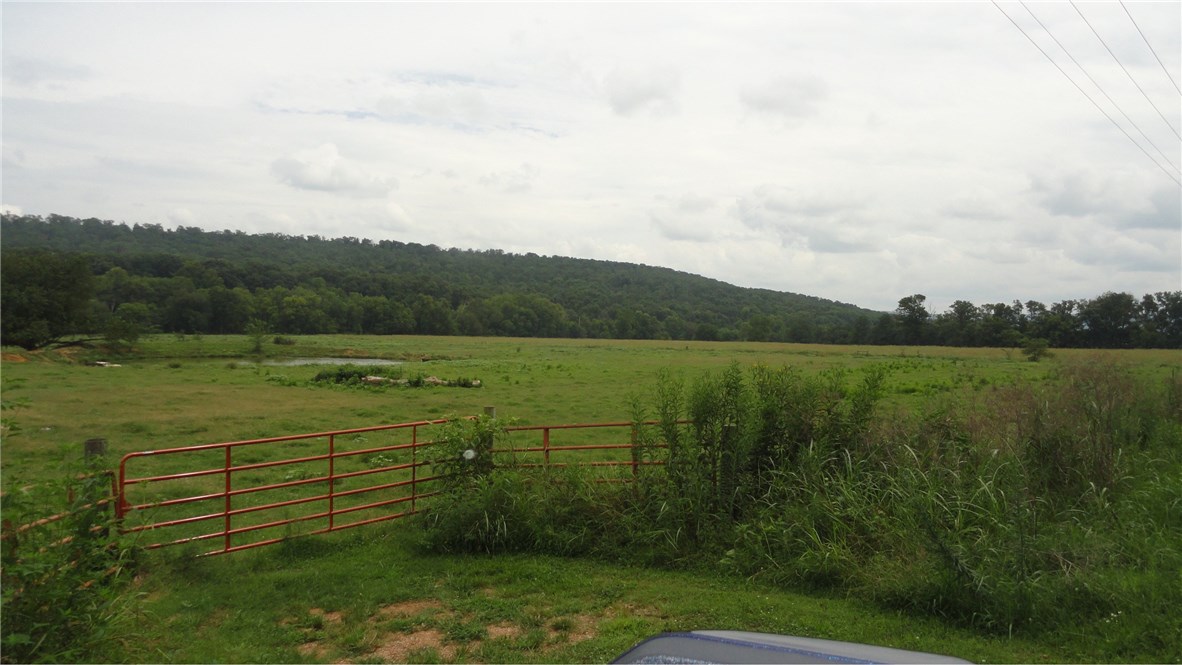 Great bottom open land that is fenced and ready for cattle. Does have a pipe corral and one barn. This listing does not include house and outbuildings, but does include the hay barn. A creek is at the back side of the property. This is a gorgeous place to build a house or farm. Agent owned