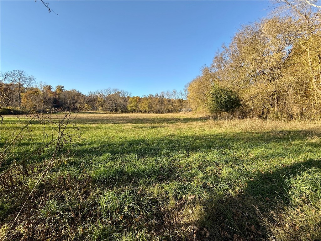 Build your dream estate on this 8.74-acre tract surrounded by natural beauty and peaceful seclusion. A perfect blend of open space and mature trees creates an ideal canvas for a custom home or private retreat. Convenient frontage along Sugar Creek Rd offers easy access while maintaining a quiet, private feel. Enjoy the calm of country living without sacrificing convenience—just 15 minutes to Rogers and 30 minutes to Bentonville. Scenic views provide the perfect backdrop for your dream residence. Adjacent tracts also for sale, MLS #1326088, 1344713, 1344718, 1344722, 1345186.