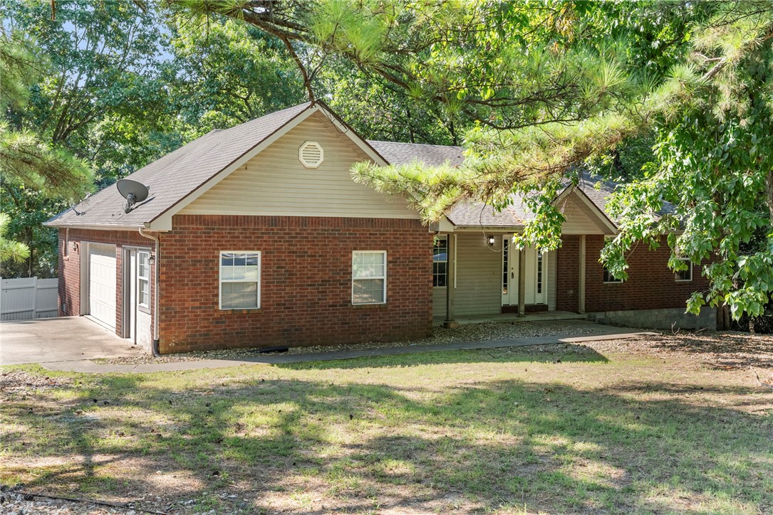 Adventure, convenience, and flexible living come together in this home, offering the best of the Bella Vista lifestyle. Set on a beautifully shaded corner lot, you'll enjoy direct access to Bella Vista's renowned biking and walking trails right outside your front door. The nearby Metfield Recreation Complex features golf, pools, tennis, pickleball, fitness facilities, and more, with several additional golf courses just minutes away. Inside, the bright 8x12 enclosed sun porch is the perfect place to relax and enjoy the peaceful surroundings year-round. A spacious 20x12 bonus room attached to the garage offers endless possibilities as a home office, studio, workout space, or hobby room. You'll also find a rare 303 sq. ft. basement workshop provides exceptional space for projects, storage, or additional flex use. With mature trees, versatile spaces, and an unbeatable location close to Bella Vista's premier amenities, schedule your private showing to see all this home has to offer!
