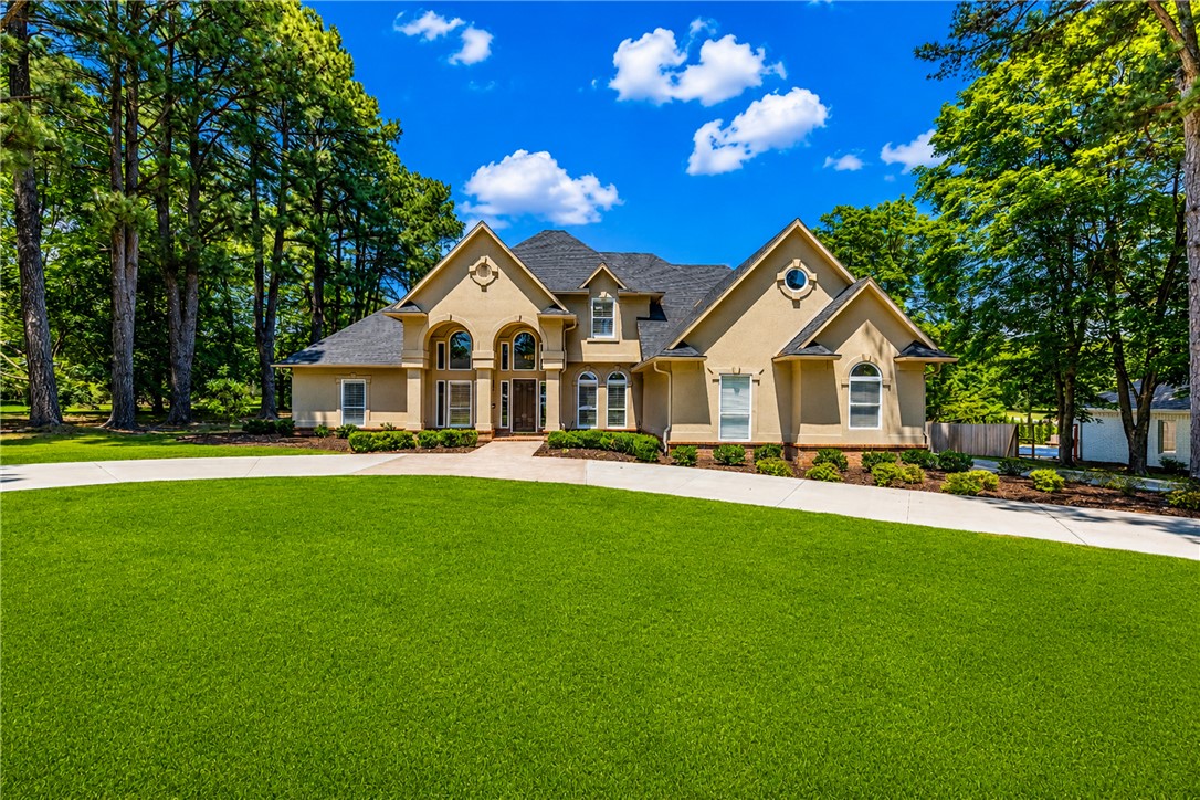 Located near Pinnacle Hills Promenade, this beautiful home offers the perfect blend of luxury and privacy on a large 0.66-acre lot. Situated in a small, established pocket neighborhood with a newly added covered patio and pool, perfect for relaxing or entertaining guests this summer. The home features two bedrooms on the main floor, hardwood flooring, marble and quartz countertops, designer lighting, and high-end finishes. The large kitchen has a gas cooktop with pot filler and ice machine. Other main floor highlights include formal dining room, eat-in kitchen, living room, and a cozy hearth room with fireplace off the kitchen. Upstairs, you’ll find two additional bedrooms, full bath with coffee/wet bar, game/bonus room, exercise room, and an office or hobby room with lots of storage. The circle drive in the front yard allows for plenty of parking for your guests. Newly added wood privacy fence. It really is all about location for this luxury home, which is 5 minutes from shopping, restaurants, and I-49.