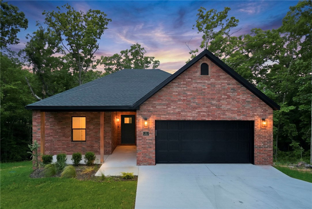 Discover outdoor living in the heart of Bella Vista! This new construction home offers the perfect blend of style, comfort, and outdoor adventure. Located near Bella Vista’s renowned trail system, this home is ideal for those who love biking, hiking, while being close to town amenities. Inside, you’ll find durable luxury vinyl plank (LVP) flooring throughout the main living areas, upgraded designer lighting, and an open-concept layout filled with natural light. Blinds and gutters installed making it move in ready. The kitchen features beautiful quartz countertops, modern finishes, and ample space for entertaining. Situated in the highly sought-after Bentonville School District, this home combines quality craftsmanship with an unbeatable location close to trails, golf, lakes, and all that Bella Vista has to offer. 11 minutes to I49, perfect for commuting into town!