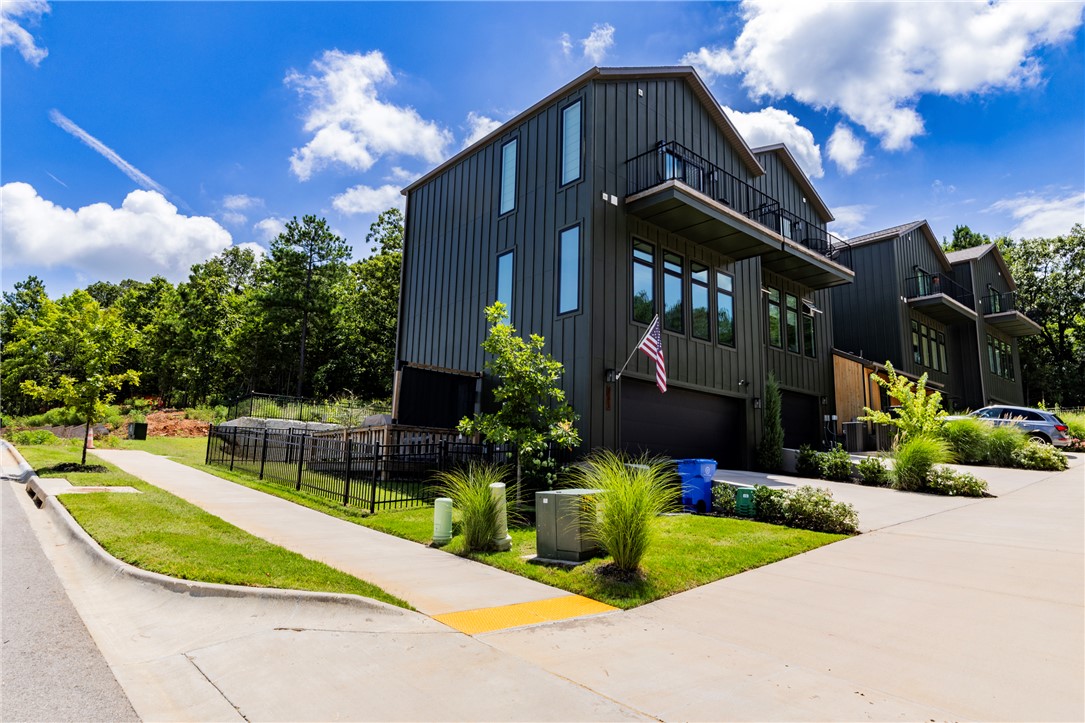 Discover 2085 E. Roe Terrace, located in one of Fayetteville's most sought after neighborhoods, Stage Station community. Built in 2024, this stylish three-story townhome offers 2 bedrooms, 2.5 bathrooms, a dedicated office, and 1,546 square feet of well-planned living space. The open layout is designed for both everyday comfort and entertaining, featuring a spacious living area with tinted windows that opens to a beautifully appointed kitchen with stainless steel appliances, generous cabinetry, and a pantry. The primary suite provides its own balcony and en-suite bath, while a second covered balcony off the main living level is the perfect spot to relax. Enjoy a low-maintenance lifestyle in one of East Fayetteville's most convenient locations, just minutes from Gulley Park, the Razorback Greenway, shopping, dining, and I-49. Residents also have easy access to Confident Coffee Roasters, soon to be community pool, and pickleball courts—all within the award-winning Fayetteville School District.