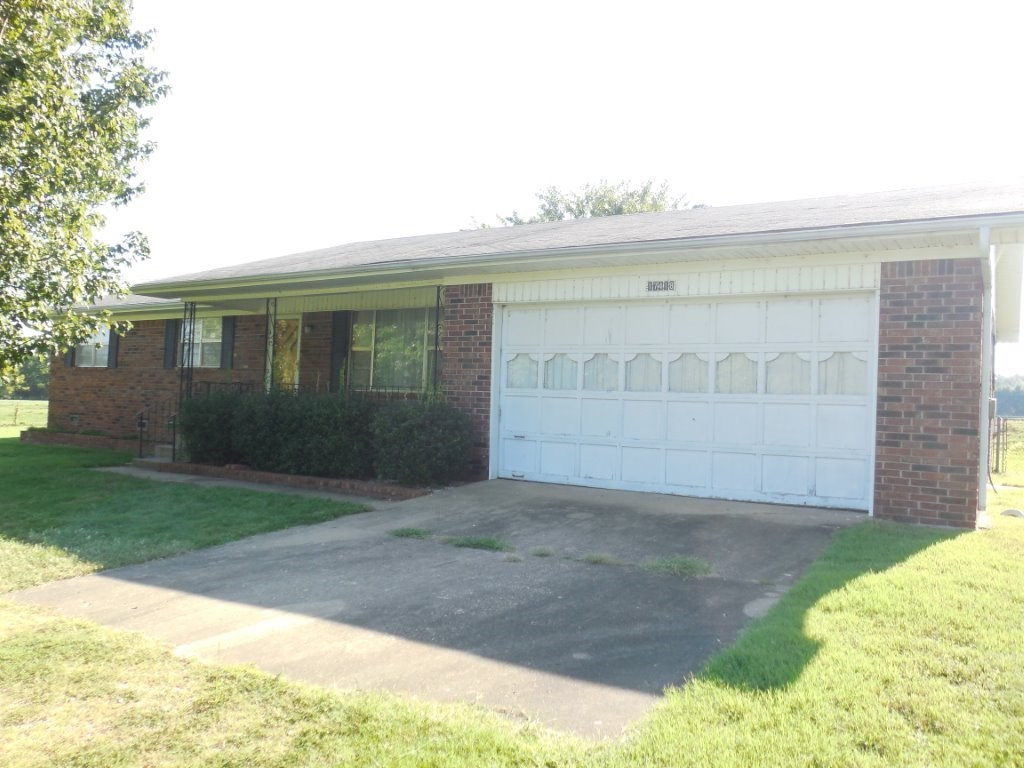 Great solid home in the county. Pretty setting, spacious rooms. I love the utility room and girl storage in garage. Great shop with concrete floors and gas outlet for heat. Additional pole barn & storm shelter. Great place to make yours. AS-IS