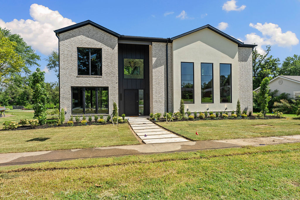 Experience elevated living in the heart of Downtown Bentonville! This stunning home features soaring 20' ceilings, open-concept living, beautiful light-filled spaces and designer finishes throughout. The gourmet kitchen offers custom white oak cabinetry, premium appliances, a beverage refrigerator and ice maker, and a spacious walk-in pantry. Private office plus an additional flex space ideal for entertaining or media room. Spacious bedrooms feature walk-in closets. Detached garage includes a private apartment with separate entrance, perfect for guests, multigenerational living, or short-term rental potential. Large lot offers room for a pool and outdoor entertaining. Minutes from the Walmart Home Office, Alice L. Walton School of Medicine, Crystal Bridges Museum of American Art, Downtown Bentonville, trails, dining, shopping, and more. A rare opportunity to enjoy luxury living in one of Northwest Arkansas's most sought-after locations.