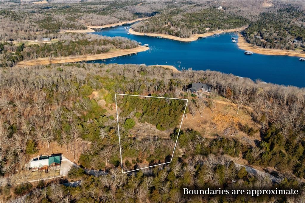 Perched at the top of Cedar Ridge in Cedar Acres Subdivision, this property offers stunning views in every direction. Enjoy exceptional privacy while still being conveniently located near lake access—an ideal setting for a peaceful retreat or future home site. Owners enjoy Lost Bridge amenities including the community pool, pickleball court, rec center, air strip, and more! If you have been dreaming of building near the water amidst natural surroundings, with space, serenity, and community perks, this is your opportunity to bring that vision to life!