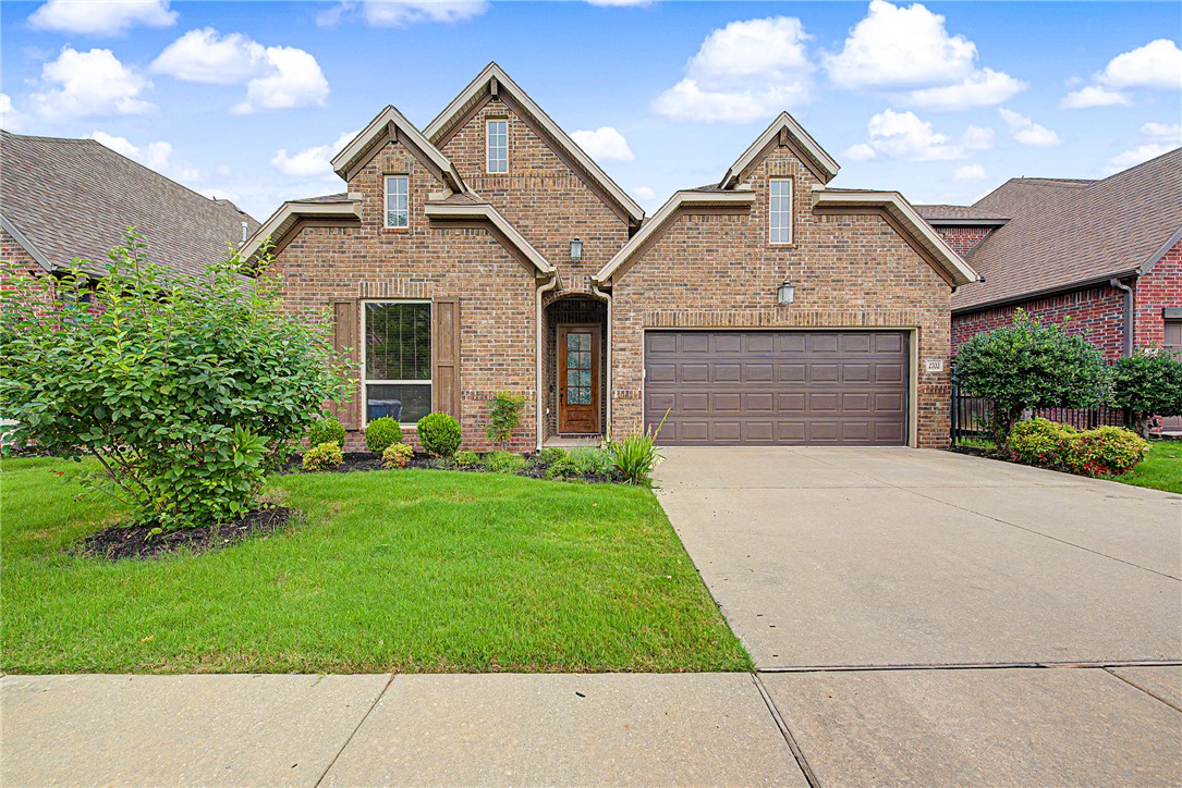 Welcome to Brighton Cottages at The Parks, where comfort and convenience meet! This beautifully maintained one-level home, built in 2018, offers 3 bedrooms, 2 baths, and 1,944 sq. ft. with a sought-after split floor plan. The bright, open living space features wood flooring, a gas log fireplace, and abundant natural light. The kitchen is designed for both function and style with granite countertops, a gas cooktop, built-in oven, large walk-in pantry, and lots of storage. The spacious primary suite, with picture windows, includes a huge walk-in closet and a tiled walk-in shower. Enjoy relaxing on the covered patio overlooking the fenced, professionally landscaped backyard with no homes directly behind. Additional features include a wired-for-sound and attached 2-car garage with 240 volt charger. POA amenities include lawn care, clubhouse, pool, park, and playground. Conveniently located near schools, trails, Bentonville Community Center, shopping, dining, and all that Bentonville has to offer!