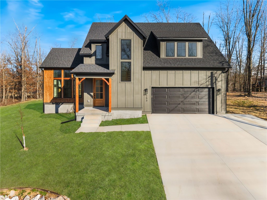 Stunning new construction near Lake Lomond in Bella Vista! This 3 bed, 2.5 bath home blends modern design with warm, natural finishes and thoughtful upgrades throughout. Hardwood floors flow seamlessly across the main and upper levels, creating a cohesive, high-end feel.

The chef’s kitchen is a true showstopper, featuring quartz waterfall island, custom cabinetry, designer lighting, subway tile backsplash, gas range, and abundant storage—perfect for entertaining or everyday living.

The private primary suite offers a spa-like bath with dual vanities, soaking tub, tiled walk-in shower, and elegant gold fixtures. Enjoy the convenience of a laundry area in the primary closet plus a full upstairs laundry room.

Upstairs you’ll also find a versatile loft and dedicated office space. Relax on the covered deck overlooking serene, wooded surroundings just minutes from Lake Lomond.