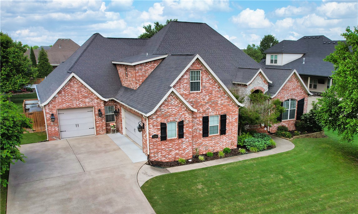 Fantastic floor plan in a prime Rogers location near the Promenade Mall, Pleasant Grove, shopping, dining, and entertainment! Located in a gated community, this 4 bed, 5.5 bath home features two spacious living areas, a dedicated office, bonus room, and beautiful hardwood floors. The large kitchen offers granite countertops, custom cabinetry, and a center island—perfect for gathering. Step outside to your private backyard oasis with a heated saltwater fiberglass pool, waterfall feature, and covered patio with outdoor fireplace. The current owners created a true retreat ideal for relaxing or entertaining. A rare find that blends comfort, convenience, and luxury!