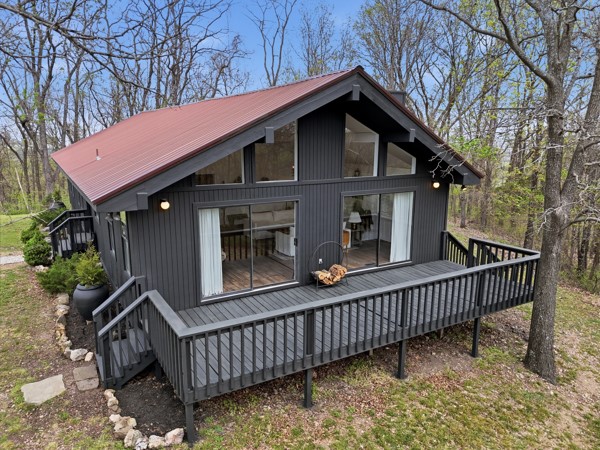 Whether you have homesteading on your heart or are searching for a prepper’s paradise, this modern Ozark home on 22 acres has it all! The gated property features a custom fire pit and entertainment area, mature fruit trees, blueberry bushes, and complete privacy with no bordering properties (a fire road borders the land). It includes a private well with filtration system, septic system, and a garden with electric fence and enriched soil. You’ll also find a custom chicken coop and run, heated and insulated dog/cat house, and a backyard dog run. Additional highlights include an alarm system, doorbell camera, wood-burning stove insert with blower, abundant wildlife, and an A/C unit under five years old. Inside, enjoy modern finishes like subway tile, wood plank flooring, clawfoot tub, and shiplap walls. With timber, natural rock formations, seasonal 360 degree views, and room to expand, this serene property is a rare find.