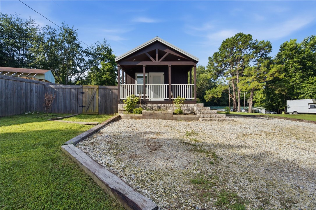 Escape to your own peaceful retreat by the lake!
This charming 1-bedroom, 1-bath tiny home is proof that great things come in small packages. Perfectly positioned to capture beautiful lake views, this cozy getaway offers the ideal blend of simplicity, comfort, and natural beauty. Whether you’re looking for a weekend escape, a full-time residence, an Airbnb opportunity, or a low-maintenance lake-area home, this property checks all the boxes. Wake up to serene water views, enjoy your morning coffee on the porch, and spend your evenings soaking in the peaceful surroundings.
Located just minutes from the highway, you’ll enjoy the feeling of being tucked away while still having easy access to shopping, dining, and everything Northwest Arkansas has to offer.
If you’ve been dreaming of affordable lake living or adding a unique investment property to your portfolio, this is one you won’t want to miss! Property leased until 7/30/2027