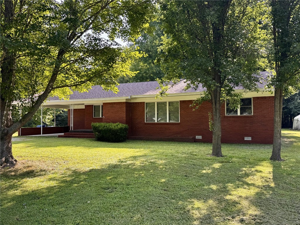 Don't miss this one-owner Fayetteville home on nearly half an acre! Located just 10–12 minutes from downtown and only minutes from beautiful Lake Sequoyah, this well-maintained property is full of opportunity. Embrace its timeless mid-century character or renovate to create your dream home. Recent updates include a new roof in 2026. Inside you'll find a spacious living room, dining area, and a functional, well-equipped kitchen. The full brick exterior, two-car carport, and generous lot make this a property with lasting appeal.