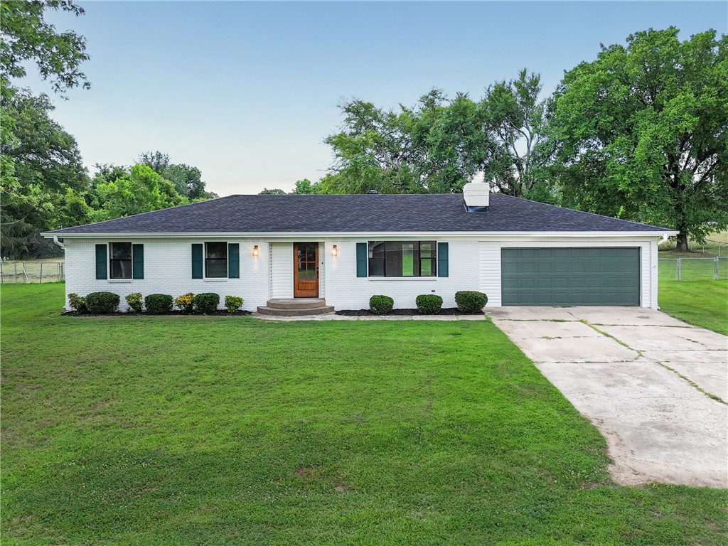 Completely remodeled and move-in ready! This stunning 3-bedroom, 2-bath home has been beautifully updated from top to bottom with stylish finishes and modern touches throughout. Step inside to find gorgeous new flooring, fresh paint, updated fixtures, and a warm inviting living space featuring a charming fireplace. The kitchen shines with brand-new cabinetry, sleek countertops, open shelving, and a fresh modern design perfect for everyday living or entertaining. Both bathrooms have been tastefully updated, and major improvements like a new roof and new hot water heater offer added peace of mind. Outside, enjoy the attached 2-car garage, spacious fenced backyard, and a convenient location just minutes from town. This home blends modern updates with timeless charm.
