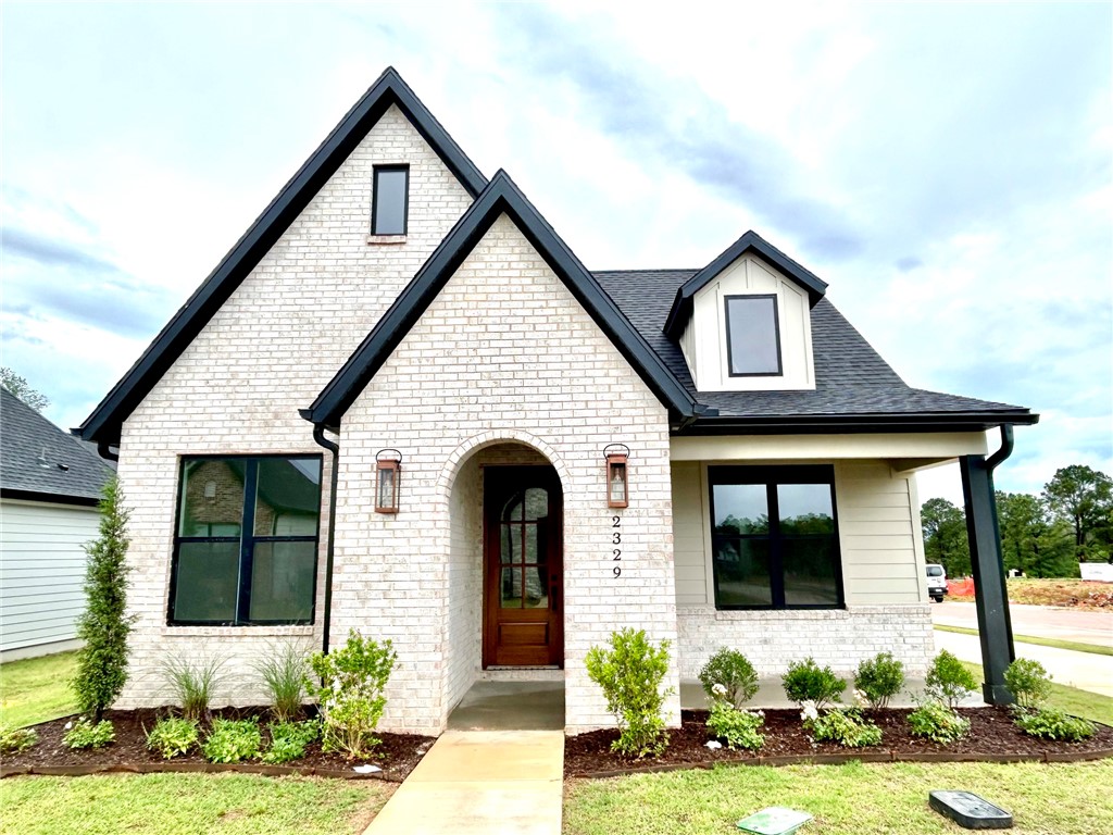 Welcome to the Witley Cottage Home at The Village at Pinnacle Hills, where luxury meets convenience. This highly desirable community is located just across from Pinnacle Hills Promenade, walking distance to Target, shopping, restaurants, and NWA's Ozark United FC, an upcoming professional soccer stadium. This beautiful new construction thoughtfully designed, two-level residence offers 4 bedrooms, 3 bathrooms, and 2,329 square feet of living. Home offers open concept layout, connecting the kitchen, dining, and living areas perfect for everyday living & entertaining. The designer kitchen features high end finishes, quartz counters, over-sized island, professional level appliances, & a spacious walk in pantry. Main level includes private primary bedroom w/ en suite, over-sized walk-in closet that enters into laundry room for added convenience, two additional bedrooms/office/bonus space. Enjoy the covered patio, mud room, 2 car garage, large 4th bedroom/bonus/game/office upstairs w/ own bathroom. POA maintains lawn.