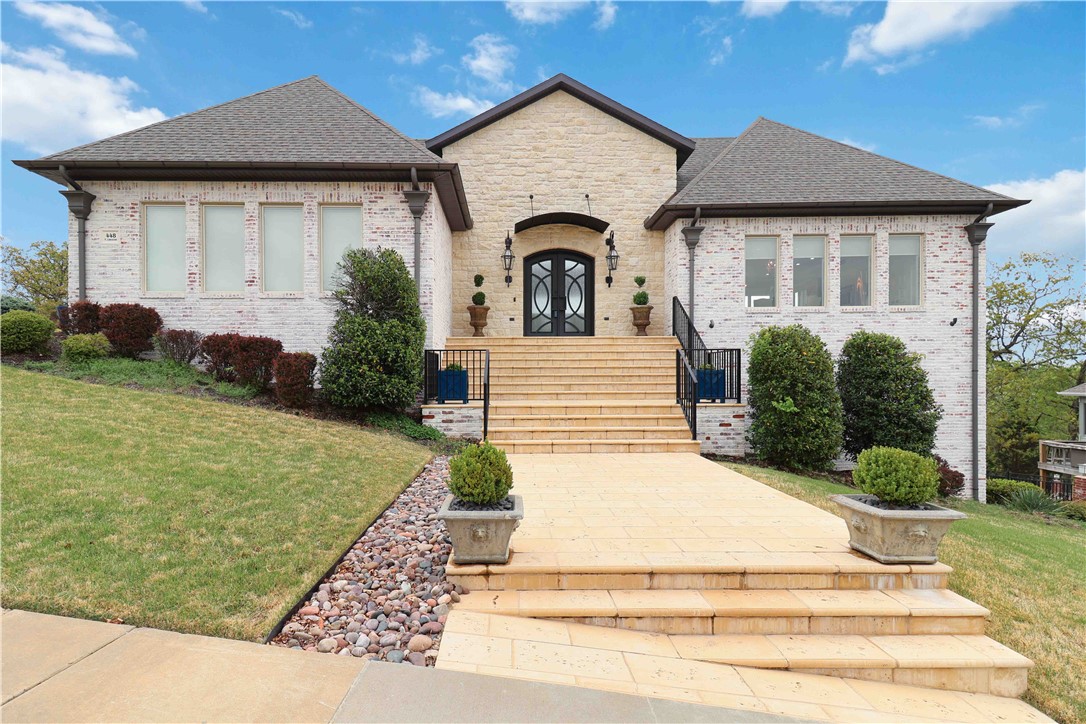 Absolutely stunning custom-built home designed for exceptional entertaining across three expansive levels. This property features 360-degree views of the Boston Mountains and Mt. Sequoyah, showcasing 65 Pella windows that flood the home with natural light.Inside, the home features 9-foot ceilings and 8-foot doors on every level, custom granite tile & and high-end finishes.This home sits on a poured wall concrete foundation and offers a superior energy rating.The chef’s kitchen is equipped with Wolf double ovens and stove, built in refrigerator, complemented by a second kitchen,ideal for entertaining large gatherings. Automated blinds, a wine cooler, cedar closet, & Pentair water filtration system for entire home and pool.Step outside to an entertainer’s dream: a 30’x20’ heated gunite pool surrounded by a spacious pool deck & outdoor kitchen.Over 30 acres of adjoining green space owned by the City of Fayetteville, this home offers a rare opportunity to enjoy some spectacular views.$5,000in preferred lender credits