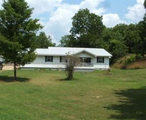 Home with acreage in the Ozark Mountains.  5 BR, 3 BA home complete with mother-in-law quarters, barn, & several outbuildings.  Property is fenced and could easily be made into mostly pasture.  Lots of wildlife in the area with approximately 9 acres. Can be purchased with additional acreage.  Adjoining property for sale.