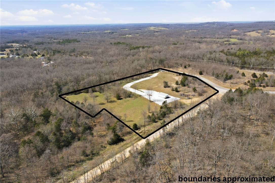Rare opportunity to own 4.21 acres comprised of 9 adjacent lots in Posy Mountain Ranch offering exceptional flexibility for a private estate, family compound, or multiple build sites. This LEVEL, cleared acreage features paved road access, a gravel prepped driveway, a 14'x30' outbuilding ideal for storage or a future water-well pump house, and TWO septic system permits (4 bedroom & 1 bedroom). The property has corners clearly marked (see photo), providing confidence and ease for future development. Located just minutes from Beaver Lake and Lost Bridge Marina, owners enjoy access to Lost Bridge Village amenities including a swimming pool, pickle ball court, recreation center, private airstrip, and more. Covenants and restrictions do apply, including a minimum 1,500 sq ft build requirement.