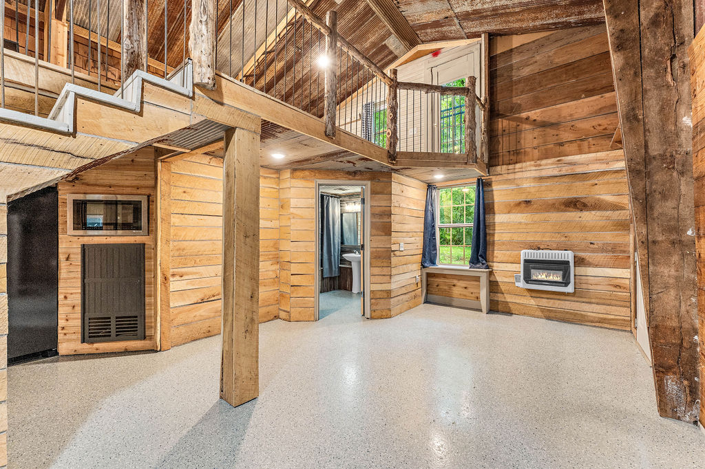Welcome to your cozy cabin retreat at 20619 Wade Rd, Springdale, AR 72764! This charming 2-bedroom, 1-bathroom home sits on a private, wooded 0.5-acre lot with no covenants, making it perfect for those seeking freedom and space – livestock welcome! The cabin features a durable metal roof and siding, while the interior blends modern and rustic elements for a warm, inviting feel. Features include a comfortable loft with one-bedroom and one bedroom and bathroom on the main level and has convenient stackable washer and dryer. Property created to impress with vaulted ceilings that enhance the open atmosphere. Three mini-split units provide efficient heating and cooling throughout the year.
Enjoy public water access and a reliable septic tank system. For added peace of mind, this property comes with a transferable home warranty. Experience ultimate privacy and the serene beauty of nature in this unique Springdale cabin in the woods!