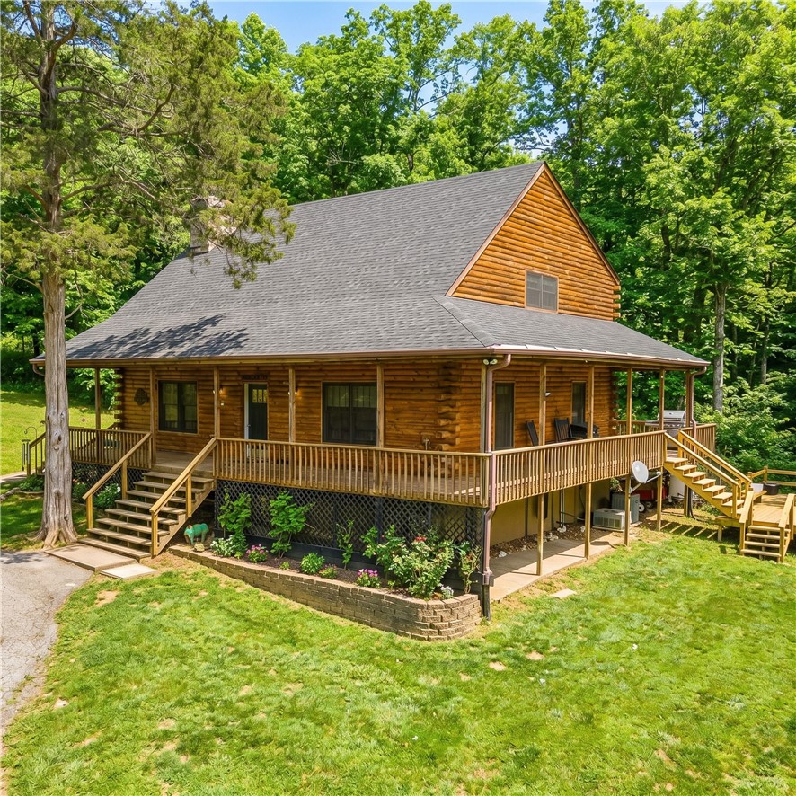 Feels like country but close to town. Log-sided home on 13.28 acres sits just outside the city limits but only 5 minutes to Drake Field, schools, restaurants and shopping. Enjoy the pastoral views from the covered wrap-around porch, hot tub, pergola or firepit. Vaulted ceilings, large loft and wood stove anchor the open floorplan. Updated kitchen with granite countertops and island plus a pantry. Private primary suite features walk-in closet, large ensuite bath with jetted tub, dual vanities and separate shower. Handy mudroom with outside door. Perfect for a hobby farm and/or nature enthusiasts with a mix of pasture and woods. Additional build sites offer flexibility. Abundant wildlife with pond and creek. Located off a paved road with circle drive, storage shed, pole barn and chicken coop. Buyer benefits from a new roof (spring 2026) and updated water heater, flooring and Andersen windows.