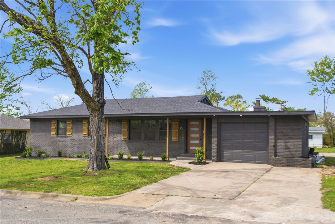 Completely turnkey and move-in ready, this beautifully remodeled Rogers home checks every box. Ideally located just minutes from downtown Rogers, dining, shopping, and everyday conveniences, this one sits right in the heart of it all. Major systems are all new — roof, HVAC, water heater, and windows — so buyers can move in with total confidence. Inside, you'll find luxury vinyl plank flooring throughout, fresh paint, retextured walls, new doors, new light and plumbing fixtures, and a stylish accent wall in the living room. The kitchen shines with new cabinetry, quartz countertops, tiled backsplash, and stainless steel appliances. Two living areas offer flexible use, one featuring a wood-burning fireplace. The primary bedroom includes a partial walk-in closet with built-ins and an en-suite with tiled shower, quartz countertops, and new vanity. Guest bath is equally updated. Laundry room with new cabinetry, tile floor, and W/D hookups. New deck, fresh landscaping, and a one-car garage complete this stunning package.