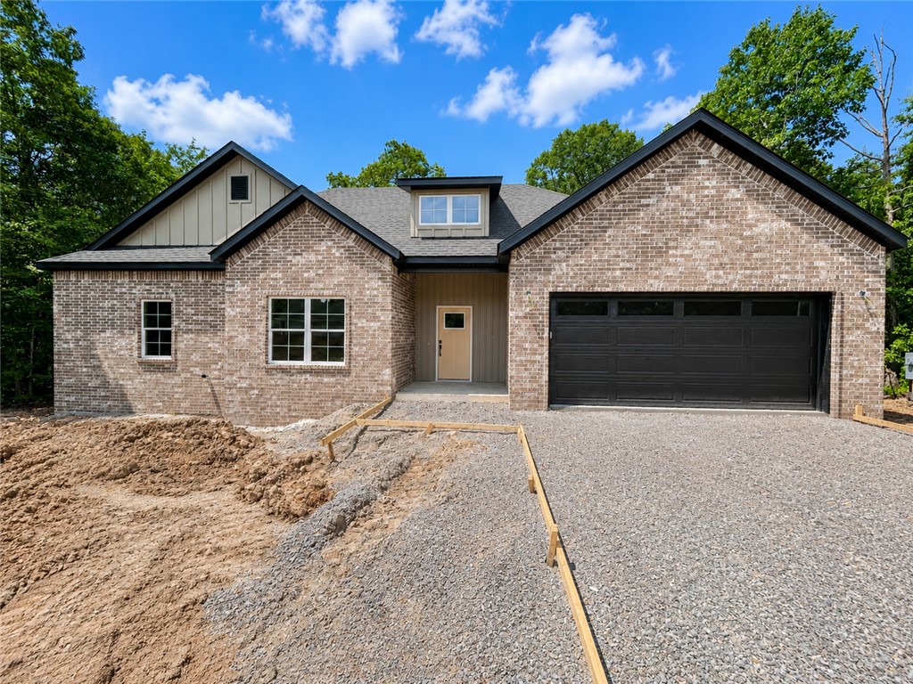 New construction on a flat wooded lot! Easy access to I-49, Highlands Golf Course, Lake Loch Lomond, and Branchwood Nature Trail / Recreation Center! Step inside to discover an inviting open concept design featuring beautiful floors that enhance the spacious feel of the home. NO CARPET! The stylish kitchen is equipped with a gas range, premium black stainless steeel appliances, 3 cm quartz countertops, custom cabinets, and a walk-in pantry. Entertain or unwind in the living area, complete with a stunning fireplace, or step out onto the huge back covered deck to enjoy the peaceful surroundings. The primary suite features a large walk-in tile shower! Buyer can receive $3,500 in closing costs when using the builder's preferred lender!