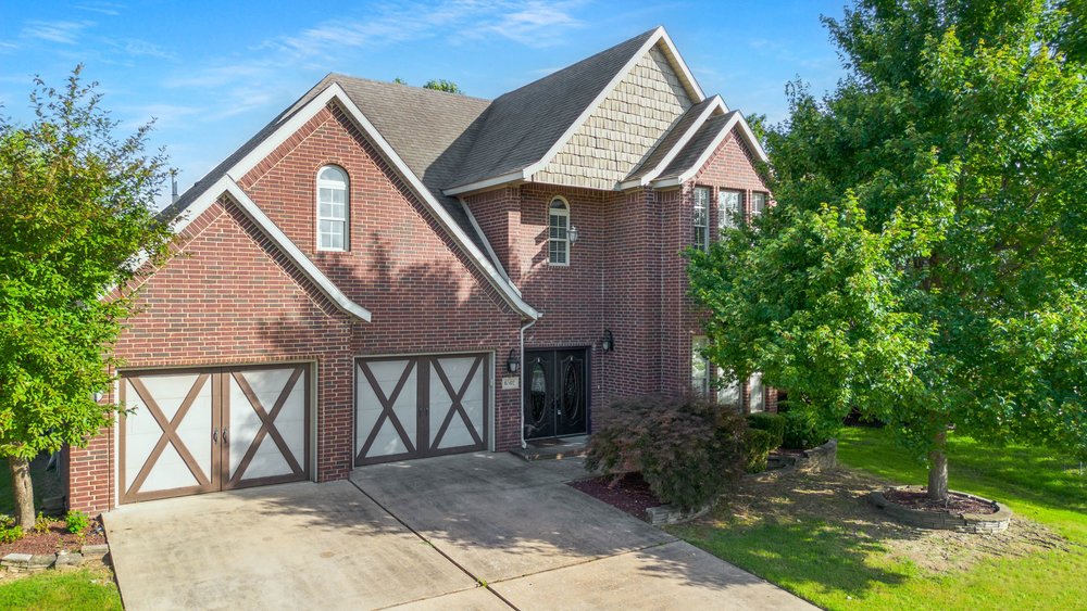 Hearthstone all brick beauty! High ceilings throughout the downstairs. Gorgeous Crown Moldings, Expansive windows makes for a light & bright home! 4 bedrooms flexible living areas, 2.5 Baths. Gleaming Hardwood floors, fun kitchen with lots of counter space, pantry, granite counters open to a gathering area with a cathedral ceiling. Going outside from this room you will enjoy a patio and a private backyard with mature trees creating shade, nice stand of grass and bushes, sprinkler system plus a storage building. Bentonville Schools, it’s so much fun with a  Neighborhood pool and playground. 2 sets of heating and air conditioning units along with 1 water heaters. Split floor plan. All rooms are nice sized. Your living area can be formal or informal with large windows.  Fenced backyard. Great location close to Pinnacle Promenade & Hospital.