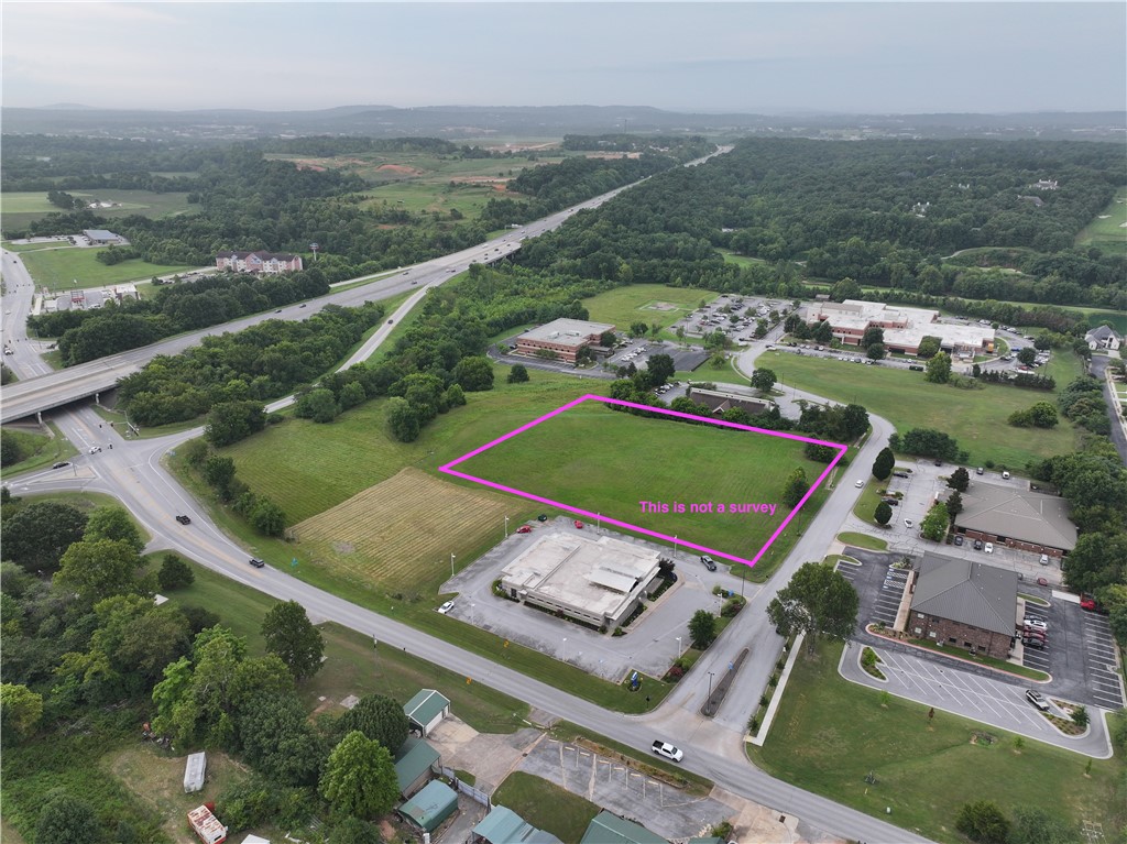 Opportunity to own property right off of I-49. Convenience and accessibility to everything Northwest Arkansas doesn't present itself often. Currently zoned TC. The property consist of 3.26 +/- acres of flat ready to build ground. Utilities are at the street.  See MLS 1307608, MLS 1326767, MLS 1326773