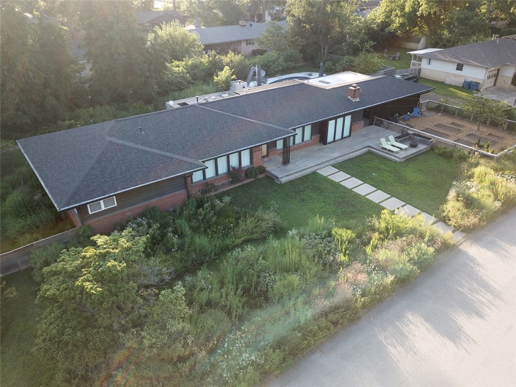 Welcome to 307 Crestview Drive, a rare fully remodeled meticulously maintained downtown Bentonville property on an oversized half-acre+ lot in the desirable NW quadrant, approximately six blocks from the Downtown Square. 
Built in the 1960s and reimagined in 2021, midcentury character blends with high-end design, major systems updates, sustainable materials, and exceptional indoor-outdoor flow. Features include 500+ sq ft heated/cooled office/ADU, saltwater gunite pool and spa, sauna, screened porch, outdoor kitchen with wood-fired oven, storm shelter, native and edible landscaping, custom carport with EV service, and private outdoor gathering spaces. Interior highlights include custom finishes, built-ins, oak