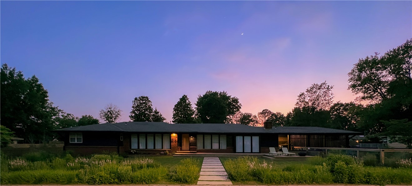 Welcome to 307 Crestview Drive, a rare fully remodeled meticulously maintained downtown Bentonville property on an oversized half-acre+ lot in the desirable NW quadrant, approximately six blocks from the Downtown Square. Built in the 1960s and reimagined in 2021, midcentury character blends with high-end design, major systems updates, sustainable materials, and exceptional indoor-outdoor flow. Features include 500+ sq ft heated/cooled office/ADU, saltwater gunite pool and spa, sauna, screened porch, outdoor kitchen with wood-fired oven, storm shelter, native and edible landscaping, custom carport with EV service, and private outdoor gathering spaces. Interior highlights include custom finishes, built-ins, oak floors, chef’s kitchen, radiant-heated bathrooms, smart home features, upgraded insulation, electrical, HVAC, roof, plumbing and main sewer line. A distinctive residence offering resort-style living and proximity to downtown, trails, restaurants, shops, and community amenities nearly impossible to replicate.