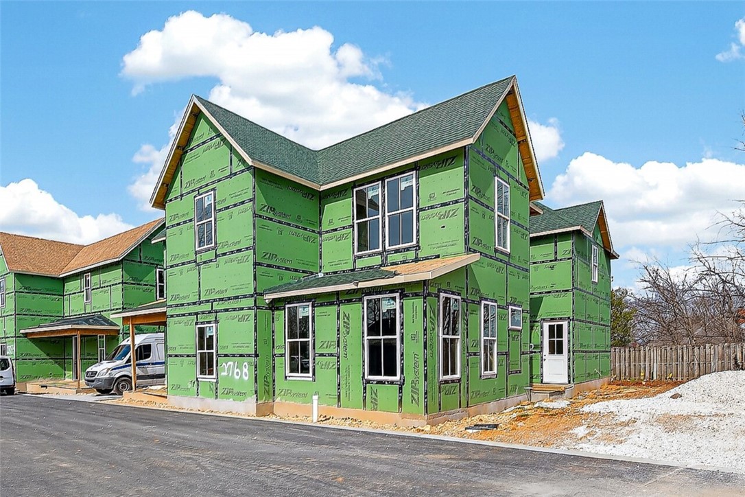 Welcome to Smyth Crossing – where history, community, and thoughtful design meet in East Fayetteville’s coveted Crossover area. Born from a vision to preserve the cherished home of immigrant Peter Smyth, this neighborhood blends heritage with modern living. Tree-lined streets, green spaces, and timeless architecture create a place to connect and celebrate the Ozarks’ beauty. Among its standout homes, The Prow House combines charm, function, and versatility. It features 4 beds, 2.5 baths in the main home- versatile space with 1-bath above the garage, perfect for guests or extended family. A welcoming front porch and private courtyard offer inviting spots for morning coffee or evening tea, while the open floor plan inside flows effortlessly for entertaining and everyday living. Luxury finishes and an efficient layout make this home as stylish as it is comfortable. Minutes from top schools, parks, trails, and shopping. More than a neighborhood, it’s a living tribute where legacies are honored and new stories begin.