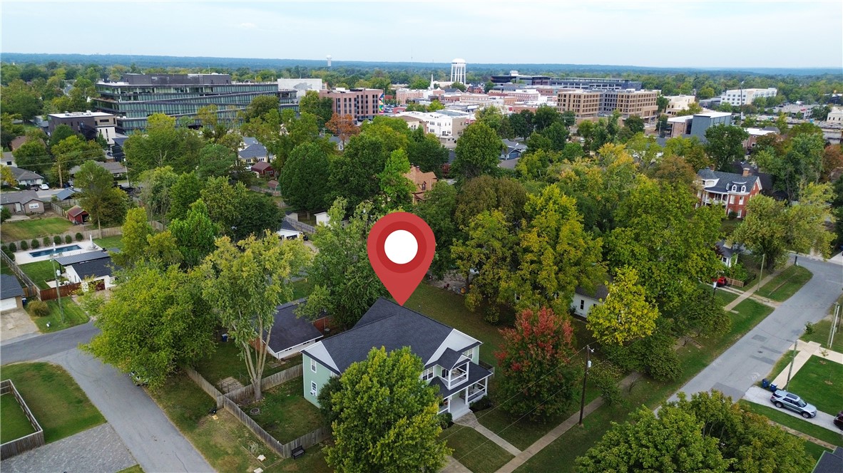 Welcome to 310 SE C Street, where timeless character meets the pulse of downtown Bentonville living. Perfectly positioned in the heart of it all, this home sits steps from the Square,Momentary, 8th Street Market- all that city living has to offer.  Fully reimagined by Dave Marrs in approx 2012, this residence blends historic warmth with modern comfort. A covered front porch sets a tone, leading to spacious living areas ideal for gathering. The kitchen features granite countertops, custom cabinetry, and connection to the formal dining room perfect for hosting. The oversized primary suite is a retreat: sitting area, spacious ensuite, private patio for quiet mornings & relaxing evenings. 3 additional rooms + an office/flex room offer versatility. Oversized garage is an added convenience. Located in one of Bentonville’s most coveted areas, this home captures the best of downtown living — walkable, welcoming, and effortlessly livable. Seller offering a $10,000 paint allowance to personalize this exceptional home.