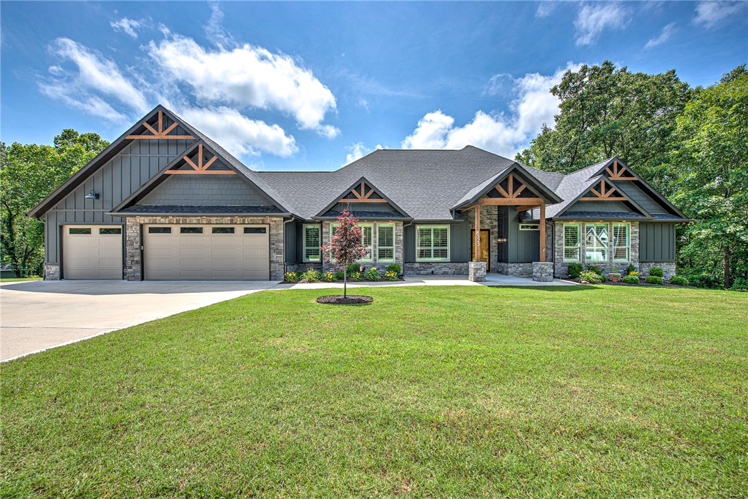Nestled on 2.56 private acres off of Plentywood in Bentonville, this exceptional 2022-built home offers a rare blend of modern luxury, peaceful surroundings, and convenient access to Bentonville and all its amenities. This thoughtfully designed home features 4 bedrooms, 4.5 bathrooms, a dedicated office, and an open-concept layout ideal for entertaining and everyday living. The gourmet kitchen includes stainless steel appliances, custom cabinetry, a spacious walk-in pantry, and a large island with additional storage. The adjoining living room showcases vaulted ceilings with cedar beams, a floor-to-ceiling stone fireplace, and expansive wooded views. Three bedrooms feature private en suite bathrooms and walk-in closets with built-ins. Additional highlights include plantation shutters, crown molding, a large mudroom, covered deck, oversized 3-car garage, and convenience to bike trails and outdoor recreation. Enjoy refined living surrounded by nature while remaining close to Bentonville’s dining, arts, and trails.