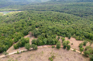 Owner financing available. terms: 20% down and seller will finance for a couple years. 13.8 m/l acres with no restrictions in very close proximity to Bull Shoals Lake with water, electric and septic on site. There are multiple building sites on the property.  Buyer to verify utilities.Property being sold multiple ways see MLS#146021 & 146022