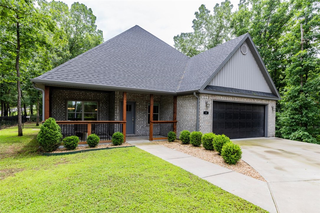 Amazing newer 3-bedroom, 2.5-bath home in a private, secluded setting with unbeatable access to Northwest Arkansas' world-class trail systems. Located less than 4 miles from Coler Mountain Bike Preserve, 4.2 miles from OZ Bike Park, just 0.1 miles from Tunnel Vision Trail, and only 1 mile from premier gravel cycling routes, this home is a dream for mountain bikers, hikers, and outdoor adventurers. Plus, enjoy an easy commute to Bentonville with only two stop signs to Walton Blvd! This thoughtfully designed home features an open-concept floor plan with abundant natural light, creating an inviting space for entertaining and everyday living. The spacious kitchen and living areas flow seamlessly to the outdoors, where you'll find a large covered front porch and a covered back patio overlooking the semi-flat backyard—perfect for relaxing after a day on the trails. This property offers the perfect blend of privacy, convenience, and the sought-after Bella Vista outdoor lifestyle.