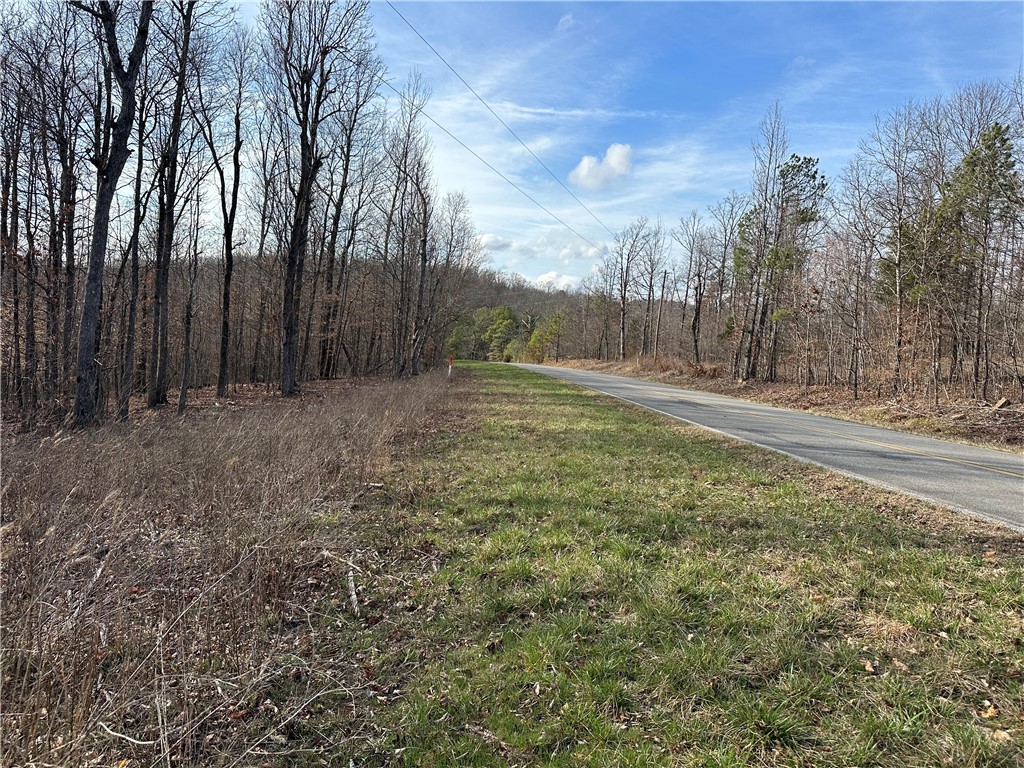 How often do you find this? 4.33 acres with paved road frontage, electric and rural water available and joins The Ozark National Forest.  Great spot to build a cabin or park your RV.  Close to Alum Cove Trail, excellent hunting right out your back door and endless opportunities for hiking and exploring.  Very nice spring on the property and very easy access off the highway.