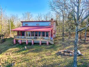 Sit on the covered back porch and admire the gorgeous view of Bull Shoals Lake and surrounding mountains or warm up inside by the wood burning fireplace.  Home boasts beautiful hardwood, pine, and cedar.  Antique wooden interior doors with original knobs.