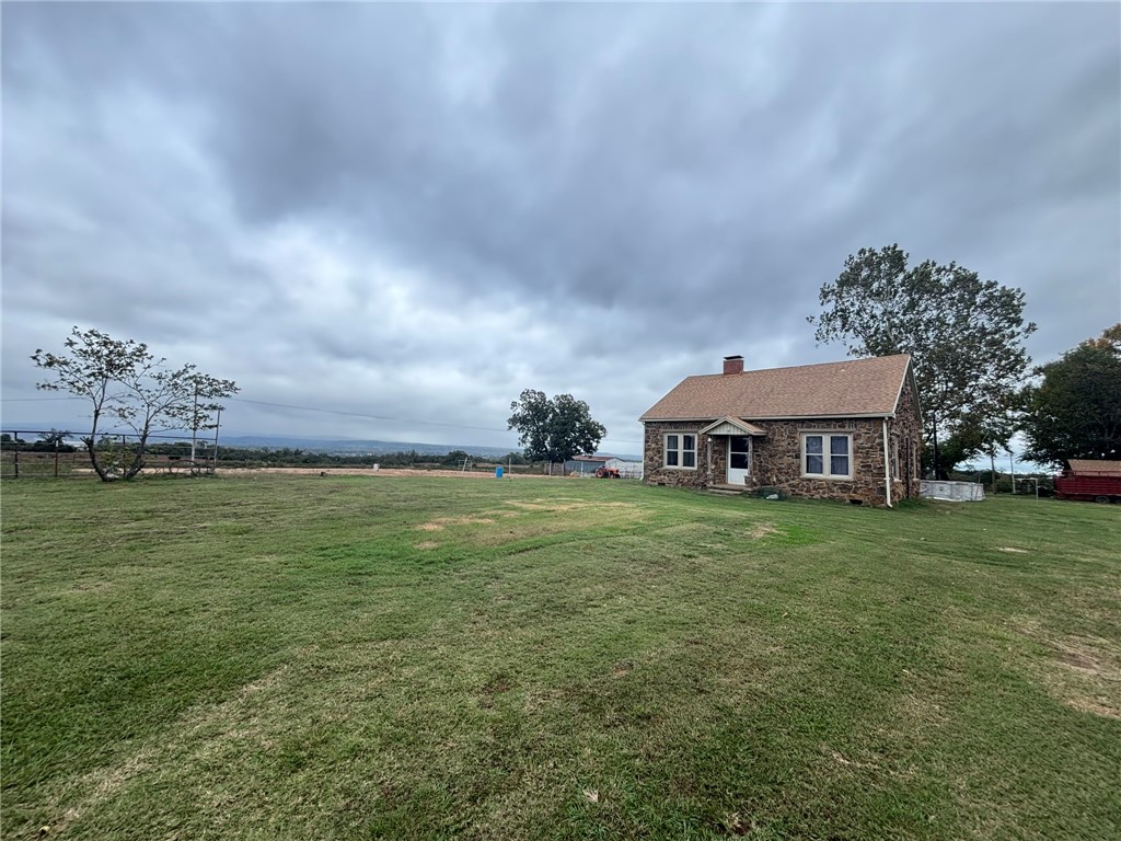 Escape to your own retreat in the heart of the Ozark Mountains.  Stunning views and pristine country side awaits.  Perfectly designed for equestrian enthusiasts or anyone seeking wide open space, this property offers the ideal blend of comfort, functionality and natural beauty.  This single level home features spacious living areas with lots of windows overlooking the pastures and a cozy fireplace.  Large kitchen and dining space to entertain for the holidays with built in breakfast bar.  The property boasts a concrete floor shop and three barns with stalls.  Completely fenced with a large pond and dock.  Plenty of mature trees and scenic views across a gentle rolling terrain.