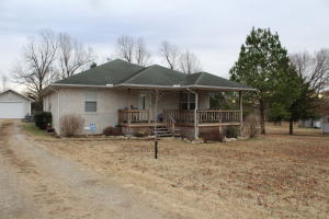 Sit on your covered front porch and enjoy your morning coffee in this quiet neighborhood or enjoy the country setting in the back yard while grilling on the open deck.  This lot is level and large enough for a garden or plenty of room for the kids to play and ride bikes on the dead-end street.  Home features hardwood and tile floors with new carpet in bedrooms, master suite with walk-in closet and low maintenance brick exterior with 6" walls for efficiency and natural gas and city water.