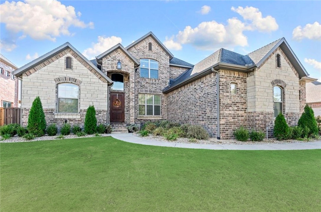 Located in the desirable gated community of Oak Tree, this home blends refined luxury with warm comfort and neighborhood amenities. Meticulously maintained, it offers an all brick and stone exterior, a covered patio with a wood-burning (gas assist) fireplace, built-in gas grill and a fully fenced, flat backyard with smart irrigation ideal for relaxing evenings, play, or a future pool. A grand entry opens to formal dining and living spaces featuring hardwood floors, elegant crown molding, and a gas fireplace. The chef’s kitchen is designed for gathering, showcasing new Stainless Steel appliances, a five-burner gas range, two ovens, pot filler, granite countertops, bar seating, walk-in pantry, and a breakfast nook with hidden storage. The primary suite feels like a private retreat with walk-in shower, jetted tub and custom closet. Enjoy a community pool, clubhouse and courts. Highlights include a mudroom, laundry, large theater room with screen and projector, storm shelter, and huge walk-in attic storage space.