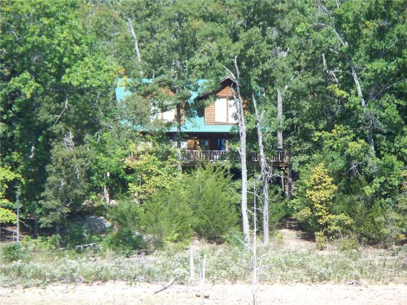 First time on the market, almost 23 acres with aprox, 2000ft of gentle walkdown lakefront.  Includes log cabin and private dock. Ready to develop or an excellent Corp or Family Retreat.  Located on open portion of Henry Hollow arm of Beaver Lake near,Point 5 and Starkey Marina by road. Has already been surveyed into 4 parcels.  Will not sell individually, must sell together