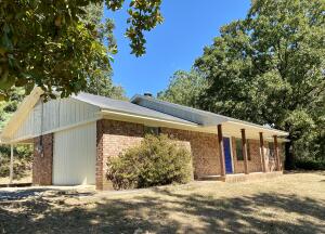 Completely remodeled residence in Western Johnson County near the AR River on 10 wooded acres with fishing pond.  Convenient location just off Hwy 64 surrounded by large shade trees offering a country feel w/ only one visible neighbor.  All new flooring, paint, & fixtures!  Updated bath!  A vaulted ceiling soars above the open kitchen, dining, & living areas.  New solid custom cabinets including a huge breakfast bar, appliances, and countertops.  Roof (2019) HWH (2022)