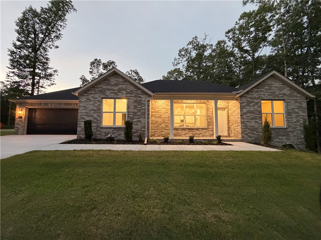 Experience the perfect blend of comfort and modern convenience in this beautiful new construction Ellison Plan in Bella Vista! Offering 2 bedrooms, 2 bathrooms, a versatile hobby room, and 1,641 square feet of thoughtfully designed living space, this home features elegant wood-look tile flooring, soaring ceilings, and an open layout ideal for everyday living. The spacious primary suite includes dual vanities with custom mirrors and a large walk-in closet. Outside, enjoy the rare benefit of a large, level backyard and an inviting patio perfect for relaxing or entertaining.  Additional highlights include energy-efficient propane heat for enhanced warmth and reliable heat should you encounter winter power outages, a propane tankless water heater, and plumbing for a propane range to provide for an easy upgrade. This exceptional home combines quality craftsmanship, modern amenities, and Bella Vista's incredible lifestyle, this home is one you won't want to miss. Schedule your private tour today!