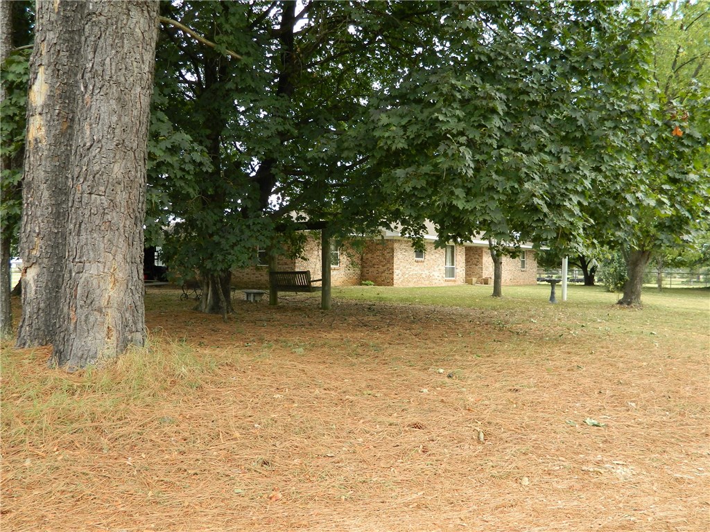 This is as working cattle ranch.  Ready for your cows or horses.  Lush pasture, 3 ponds, one is fish stocked,  and out buildings.  40 X 80, Covered,  cattle working area , with pipe fencing and loading ramp.  The home is a well kept 4 bedroom, Brick country home with 2 car attached garage.  Extra large utility room.  Eat in kitchen. Gas log fire place in living room.  Easy access to town, Schools ,  shopping and Interstate  40.  About 30 miles from Ft Smith AR.  This is country living at its best.