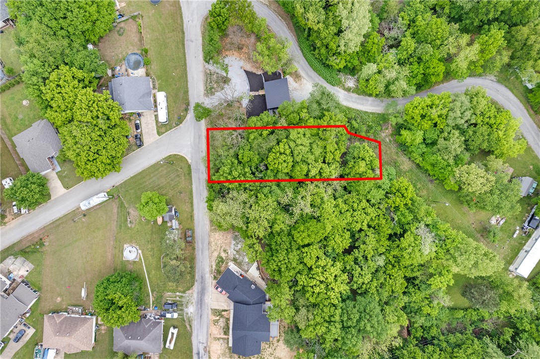 Beautifully positioned near Beaver Lake, this 0.26-acre lot offers an exceptional opportunity to build your dream getaway, full-time residence, or investment property in a scenic natural setting. Surrounded by the beauty of the Ozarks, the property provides a peaceful atmosphere with convenient access to boating, fishing, swimming, hiking, and all the outdoor recreation Beaver Lake is known for. Whether you're envisioning a cozy cabin retreat or a custom lake-area home, this lot offers the perfect canvas to bring your vision to life. Enjoy the tranquility of nature while still being within easy reach of nearby amenities, dining, and entertainment. A wonderful chance to own land near one of Springdales' most desirable destinations.