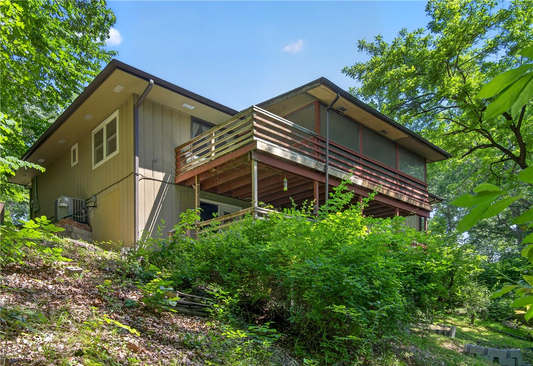 Seller offering $9,000 toward a rate buy-down or closing costs! Live in the heart of Northwest Arkansas’ premier mountain biking destination. This spacious home features a stunning mature Kousa Dogwood tree, offering beautiful blooms and exceptional curb appeal. Inside, you’ll find 4 bedrooms plus a bonus room that can serve as a 5th bedroom, office, or flex space, along with two living areas and two fireplaces. Enjoy the outdoors from the screened-in covered patio and additional outdoor living spaces. Located less than 10 minutes from OZ Trails Bike Park, the new bike lift, Tunnel Vision Trail, Lake Avalon, and US-71, and only 5 minutes from Walmart. Whether you’re looking for a primary residence, biking retreat, or investment opportunity, this property offers outstanding access to all Bella Vista has to offer. Bella Vista POA amenities include golf courses, lakes, pools, tennis facilities, and miles of recreational trails. Home is served by a 2-bedroom septic system.