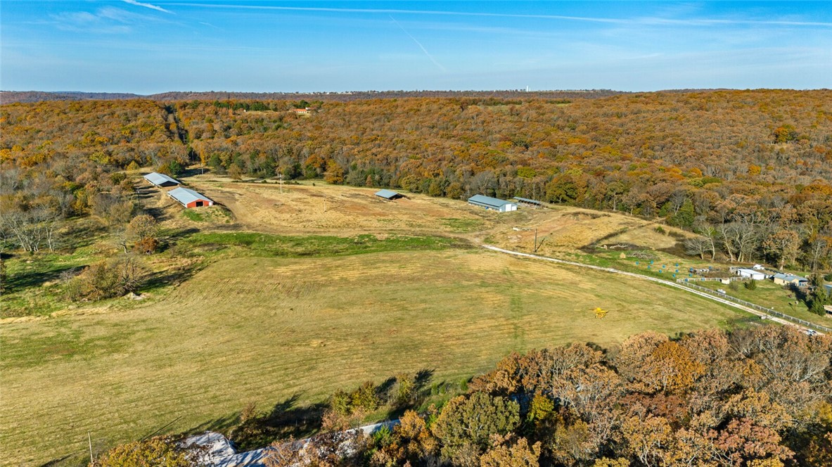 13 MOL in the Boston mountain area of NWA ideally located between Fayetteville and Devil Dens State Park and recreation area on paved highway 265. Approximately 20 minutes to Fayetteville 10 to 15 minutes to Prairie Grove, Westfork or Greenland. Property has a nice mix of woods and pasture and many building sites with a wet weather creek. There is an existing well condition unknown. Washington water is at the road. New 220 power service installed 2025 next to the well on one of the several building sites. Also includes two large sheds, suitable for machinery, hay or cattle. Beautiful property ready for whatever you are dreaming of.