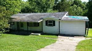 Nestled just outside of town is where you will find this home with large detached workshop and an additional outbuilding.  Home features 3 bedrooms, 1 bath, dining area, kitchen, living area and garage has been enclosed for bonus room.