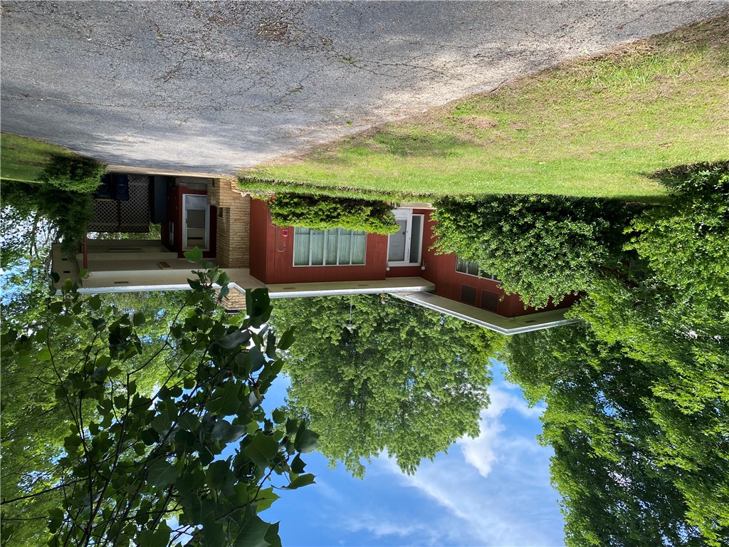 3 Bedroom 1 and 1/2 bath contemporary home with wood siding on lot on paved road. Close to schools and other city amenities. Has central heat and air, dishwasher, counter top, cook surface with built in oven. Rooms are large and there is a fireplace in den. Rolled asphalt roofing.
