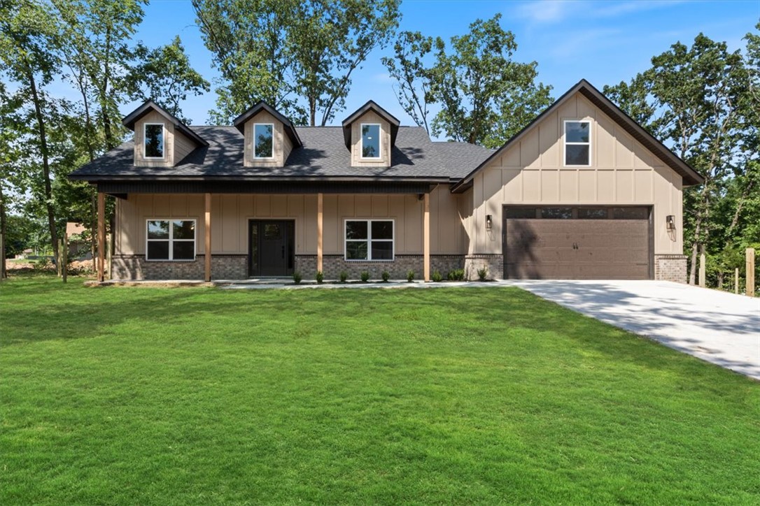 Stunning new construction home on a beautiful wooded lot! Just minutes from Lake Loch Lomond, Tunnel Vision Trail, and I-49! Features include a modern kitchen with floor-to-ceiling custom cabinets, a gas range, and luxurious 3 cm quartz countertops. Enjoy a flexible layout with 3 bedrooms (2 on the main level), a designated flex room, and a large upstairs bonus room. The primary bath offers a luxurious retreat featuring an oversized custom tile shower with glass and a large walk-in closet. Step outside onto the huge deck featuring a wood ceiling and beautiful views, perfect for entertaining or relaxing. Epoxy floors in garage! $3,500 in buyer’s closing costs when using the builders preferred lender.